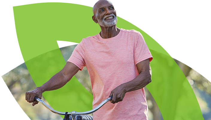 Hombre mayor sonriendo y sosteniendo su bicicleta​​ 